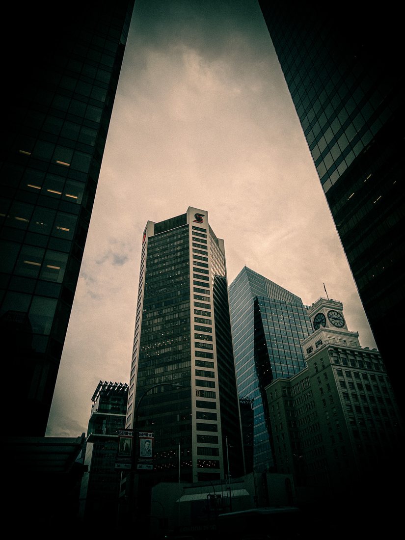 Granville Street towers converging overhead with the Vancouver Block clock tower